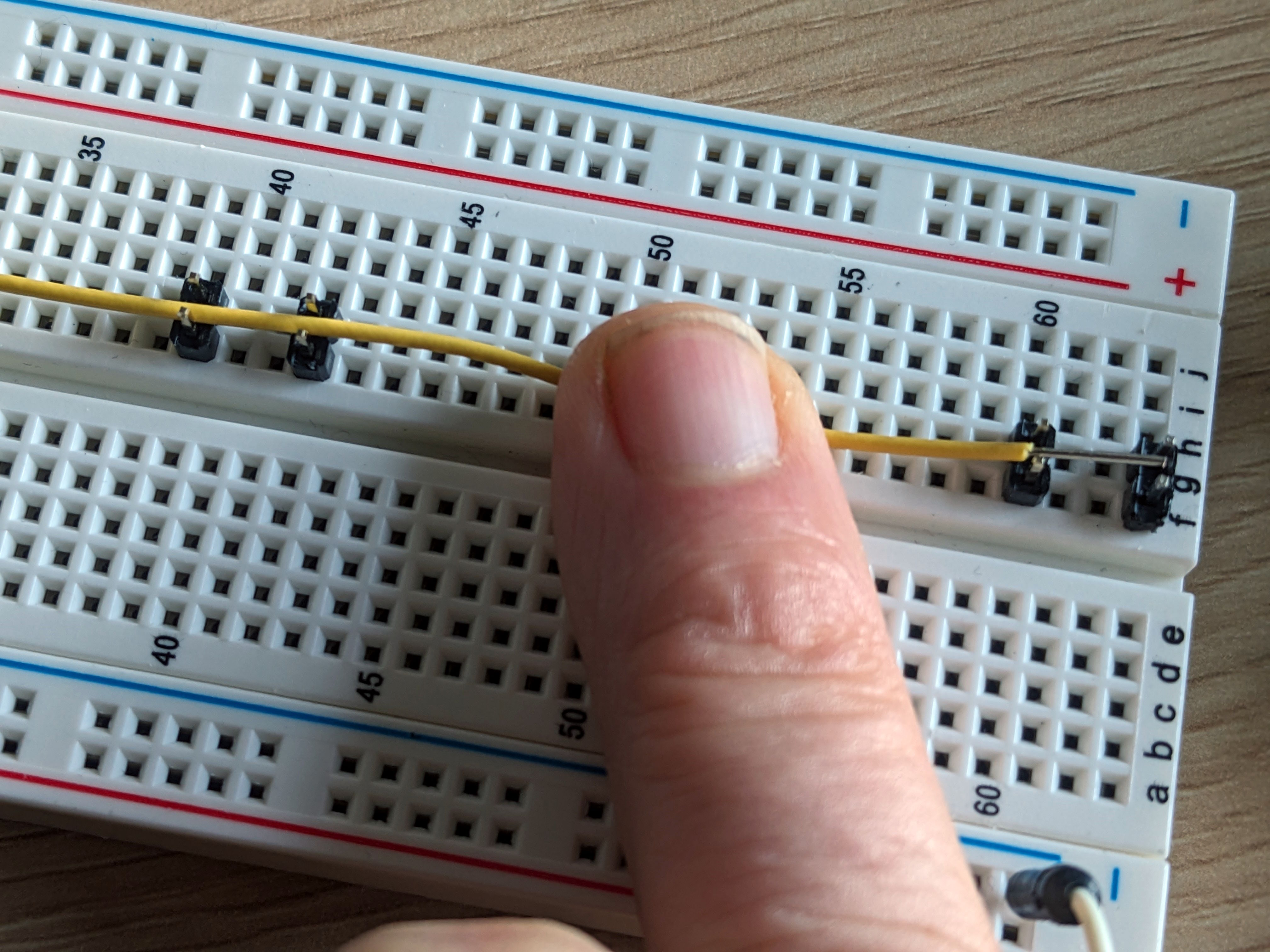 Jumper headers breadboard jig with a wire